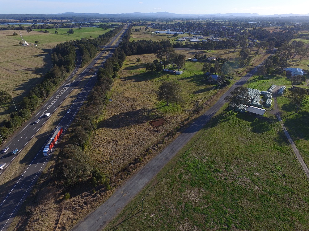 Looking south over the proposed Taree depot location distinguished by the triangular block of land. Note the JPT truck heading north on the highway.